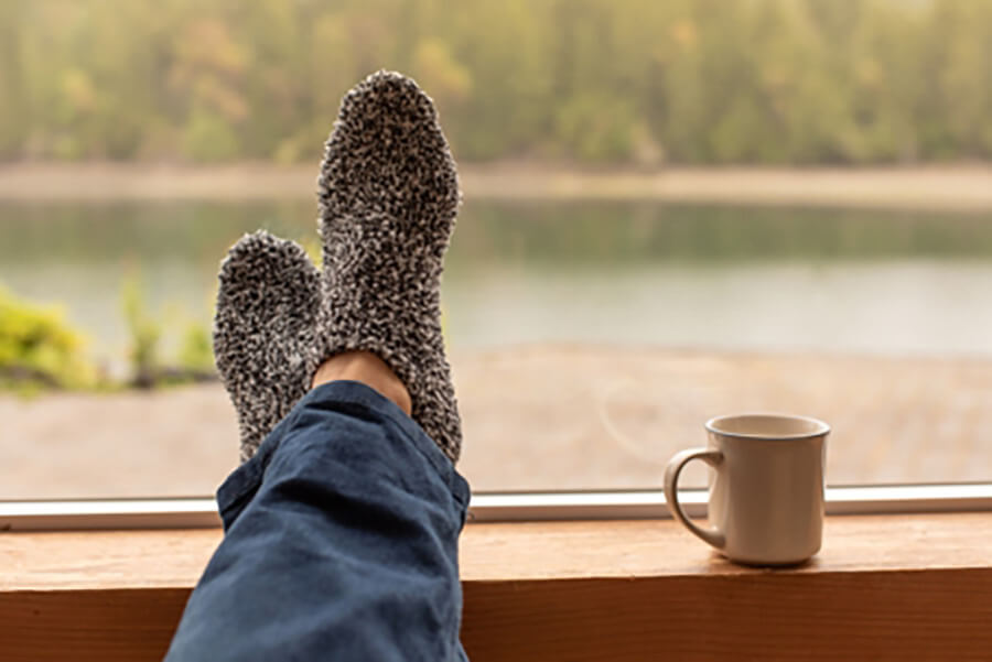 Homeowner enjoying indoor comfort while saving on heating bills
