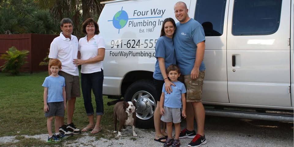 Family standing beside Four Way Plumbing service van before joining Pro-Tec