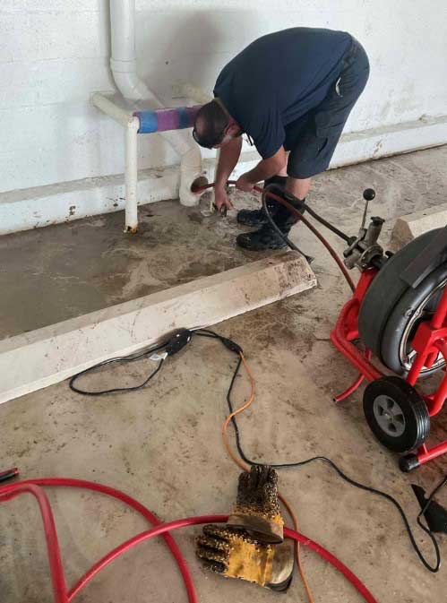 PRO-TEC technician clearing a clogged drain using equipment in Naples FL