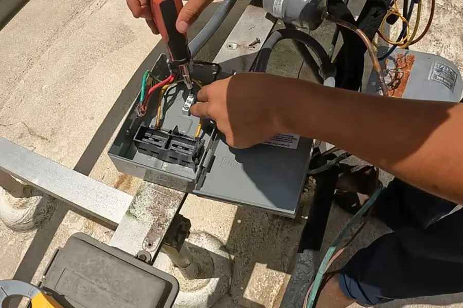 PRO-TEC technician performing commercial HVAC repair on rooftop unit in Naples FL