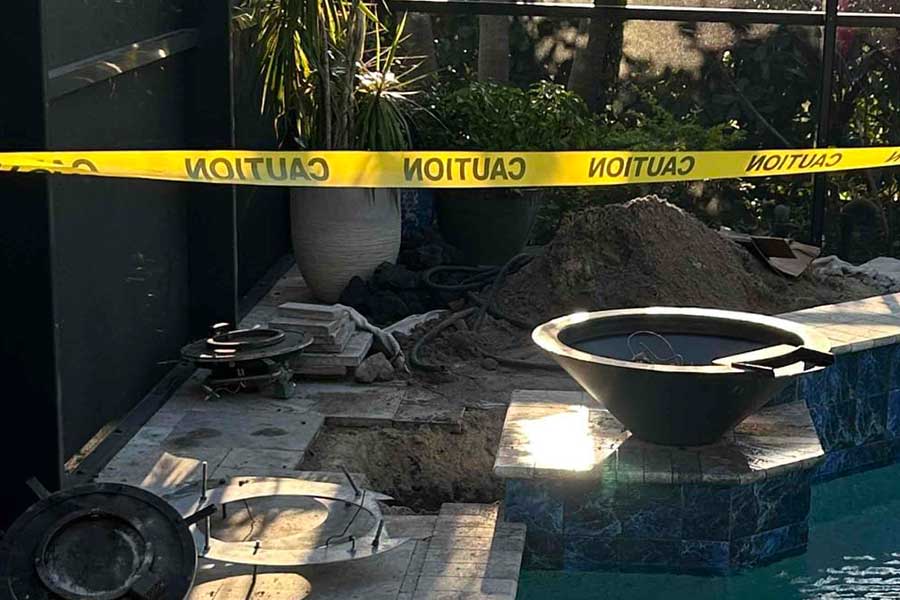 Gas line repair work in Naples FL with caution tape and excavation area