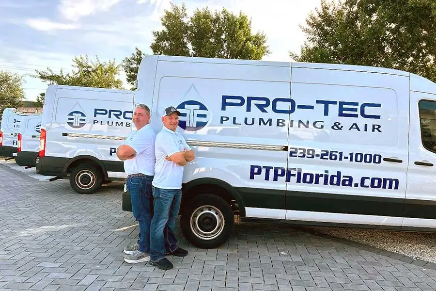 PRO-TEC team standing by service vans for home maintenance plans