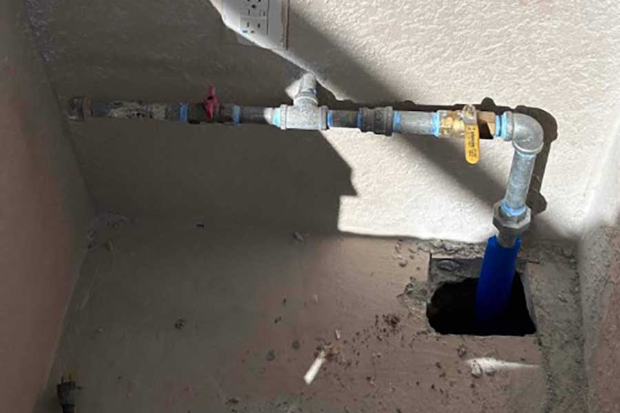 Inspecting an exposed gas line during repair work in Naples FL