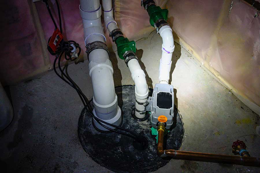 Installed sump pump system protecting a Naples FL basement from flooding