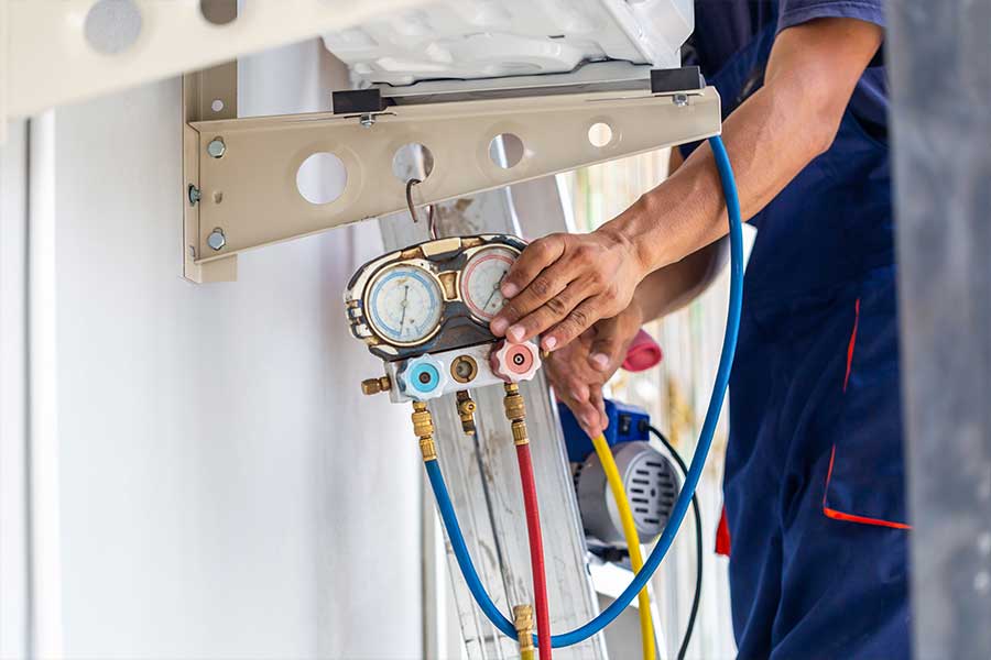 PRO-TEC technician checking heat pump system for repair in Naples FL