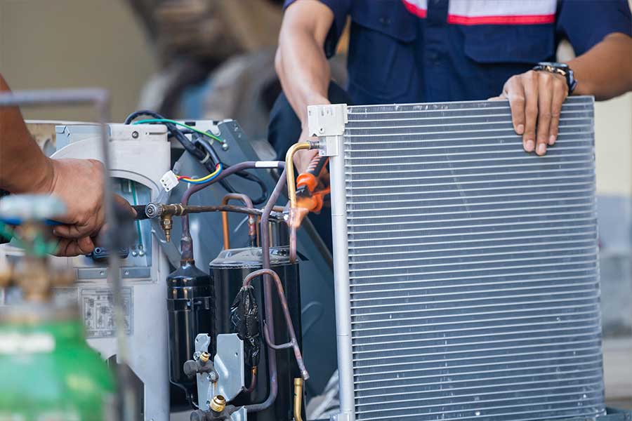 AC repair technician checking a unit in Golden Gate FL