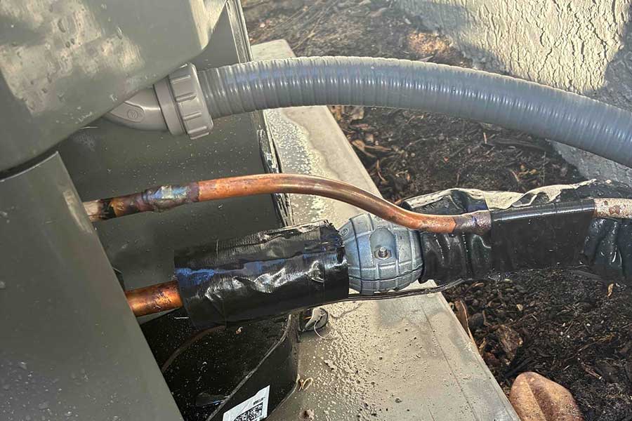 Checking copper lines during AC repair service outside a home in Fort Myers FL