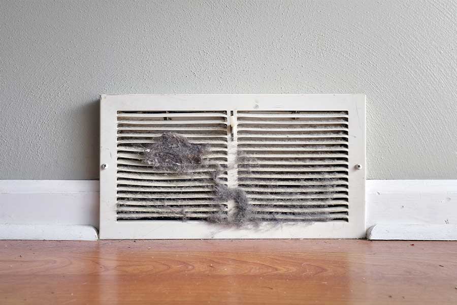 Indoor air vent with heavy dust before duct sealing in Naples, FL