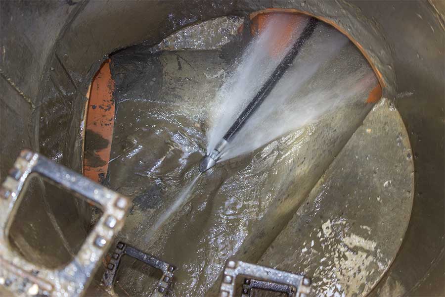 High-pressure hydro jetting clearing debris from a sewer line in Orangetree, FL