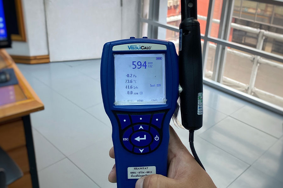 Indoor air quality testing equipment showing carbon dioxide and temperature readings