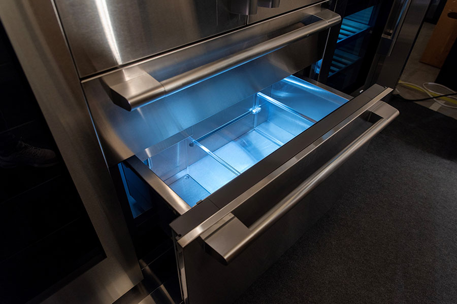 Commercial ice machine with illuminated storage drawer during service inspection